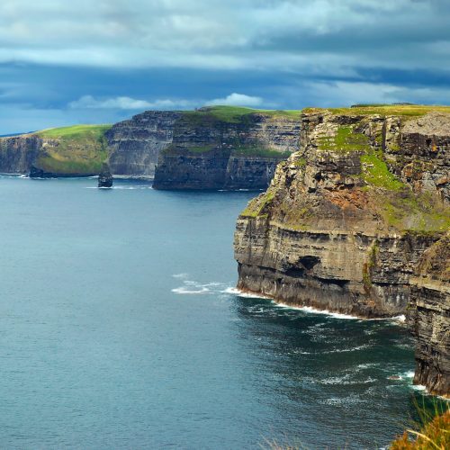Atlantic ocean with view on Cliffs of Moher in County Clare, Ireland